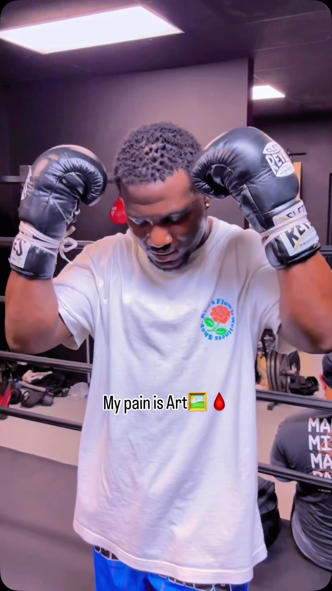 Kenneth Sene in gloves with his head bowed, captioned My pain is Art